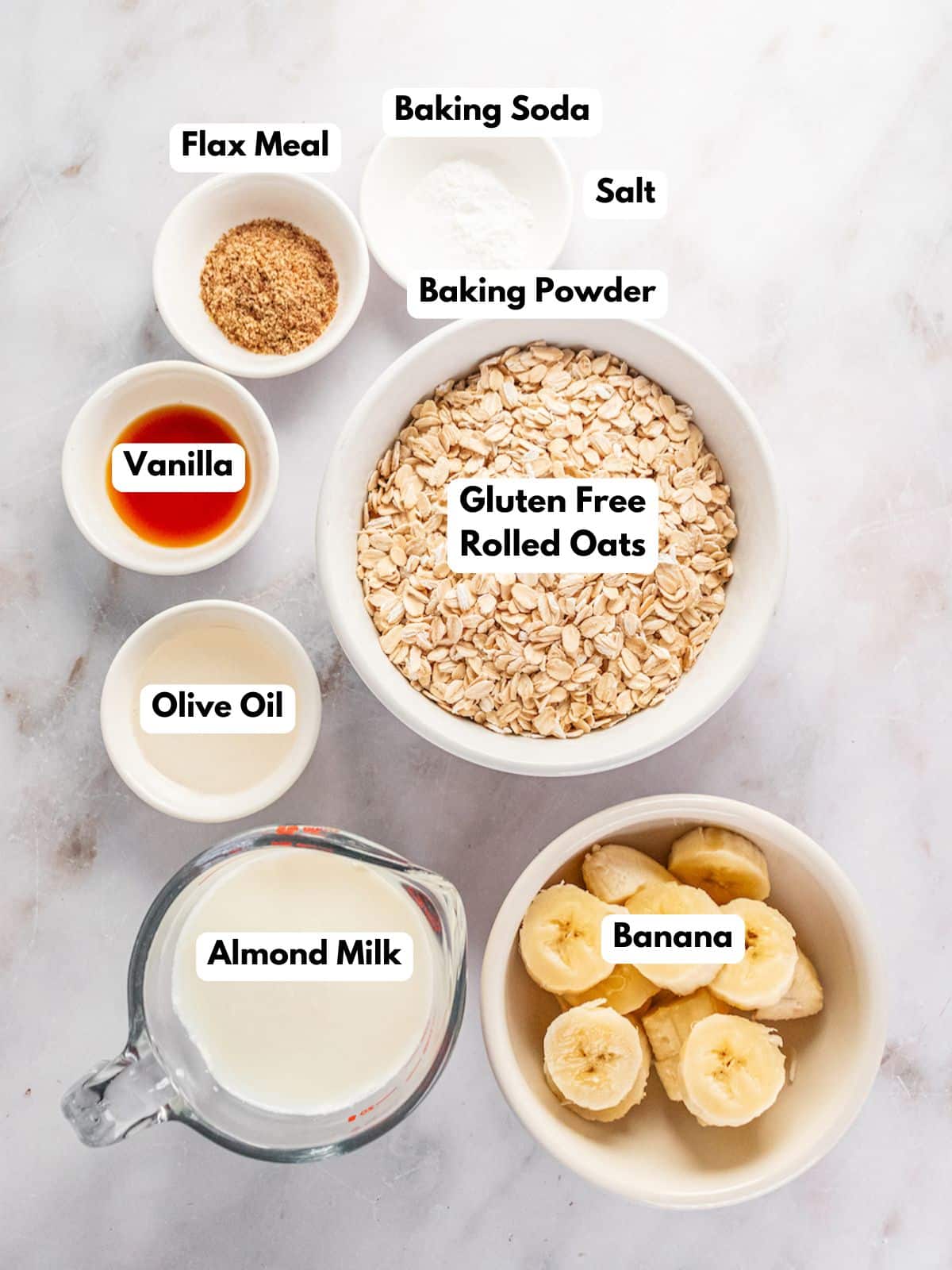 Ingredients to make banana oat pancakes on a table with text labels.