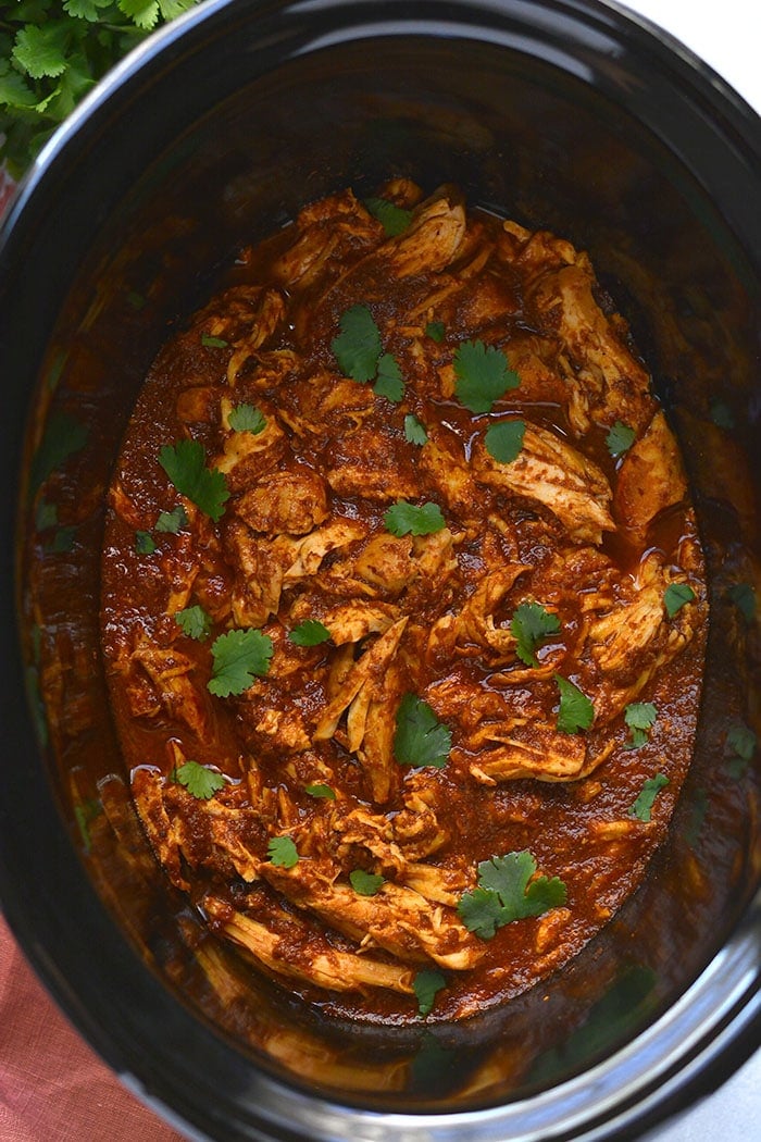 Healthy Crockpot Chipotle Chicken! This easy shredded chicken recipe made in a slow cooker is perfect for meal prep. Toss over a salad, on tacos, a sandwich or in a bowl with veggies.