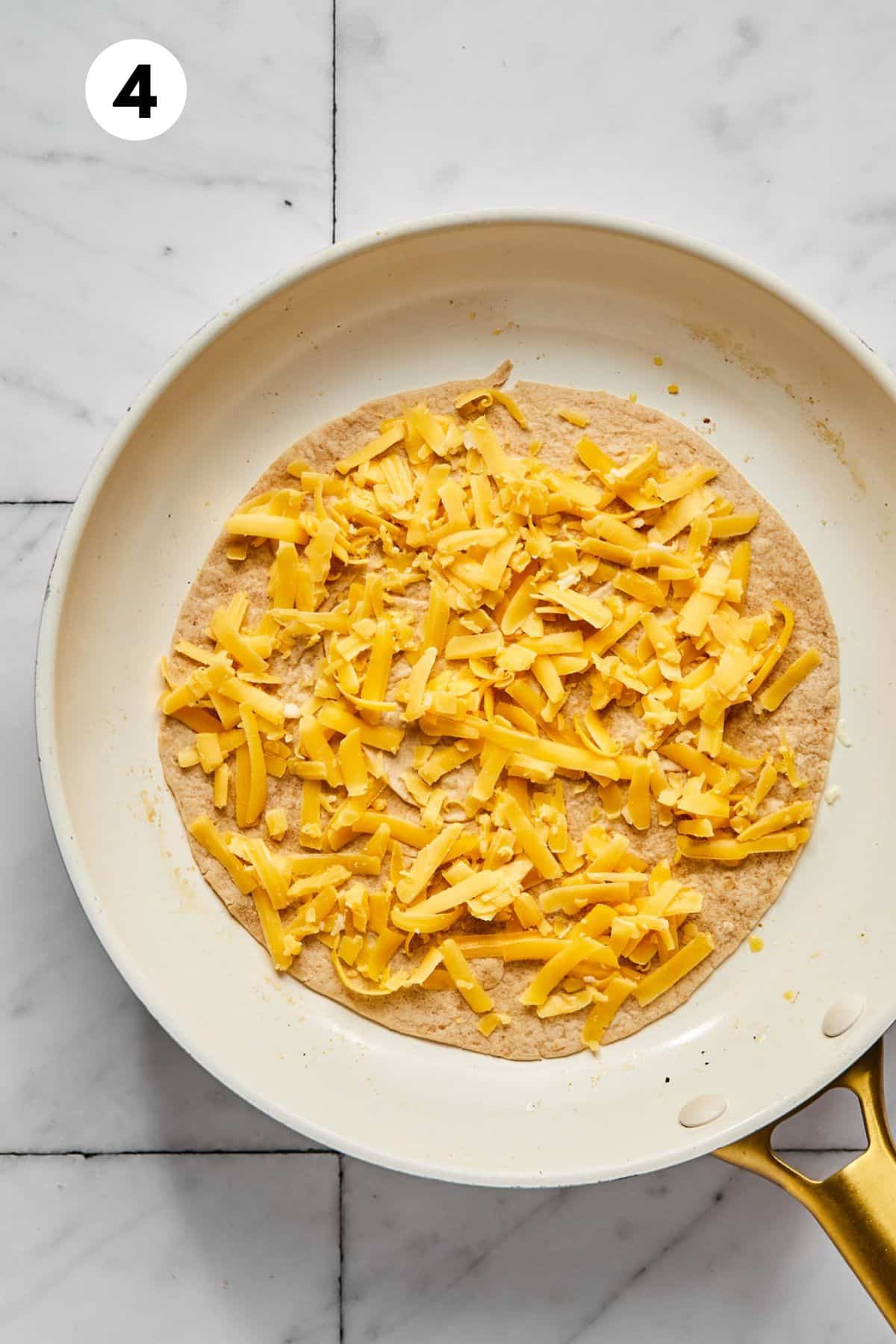 Cheese added on top of the tortilla.