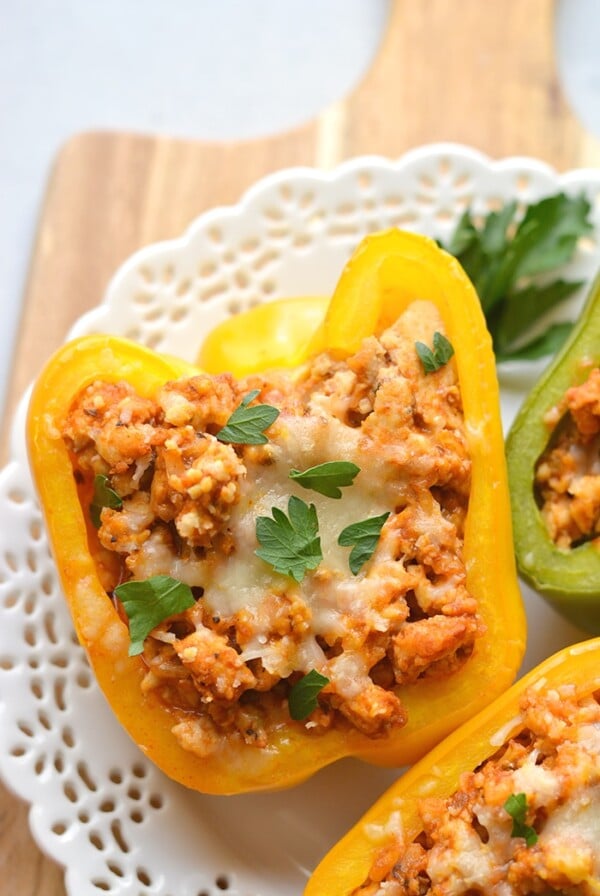Italian Chicken Stuffed Peppers are a simple low calorie dinner to make! A delicious and hearty mixture of chicken, rice, pizza sauce and seasonings. These peppers are great for meal prep and reheat perfectly. Low Calorie + Gluten Free