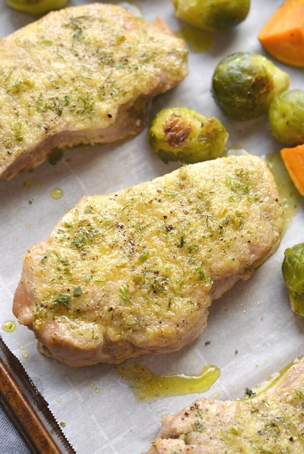 Healthy Ranch Pork Chops baked on a sheet pan with veggies for an easy, low calorie dinner packed with flavor! Easy to make and easy to cleanup too. Low Calorie + Gluten Free + Dairy Free + Paleo