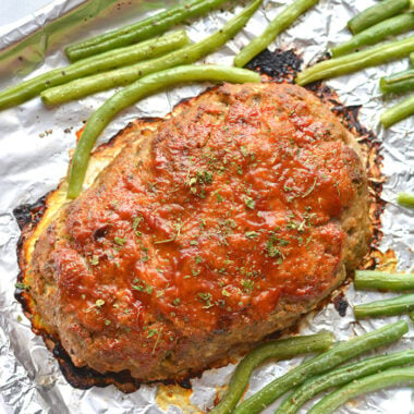 Healthy Turkey Meatloaf baked on a sheet pan. This easy low calorie dinner recipe is simple to make, egg free, hearty, gluten free and family approved! Low Calorie + Low Carb + Gluten Free
