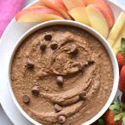 chocolate hummus in a white bowl with fruit