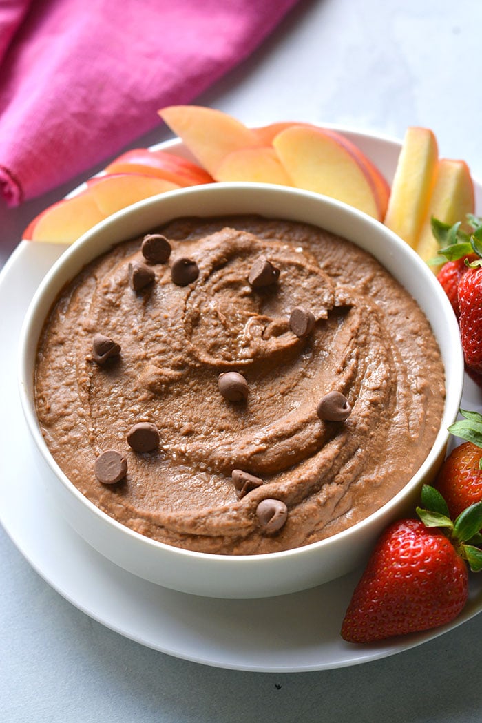 strawberries apples with bowl of chocolate hummus