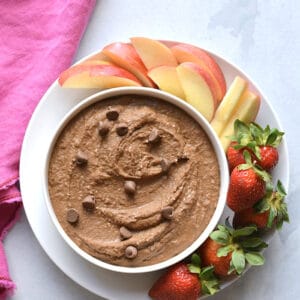 strawberries apples with bowl of chocolate hummus