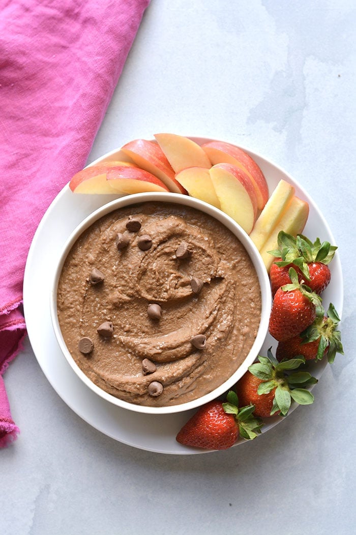 strawberries apples with bowl of chocolate hummus