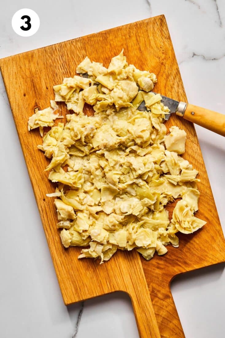 Artichokes chopped on a cutting board.