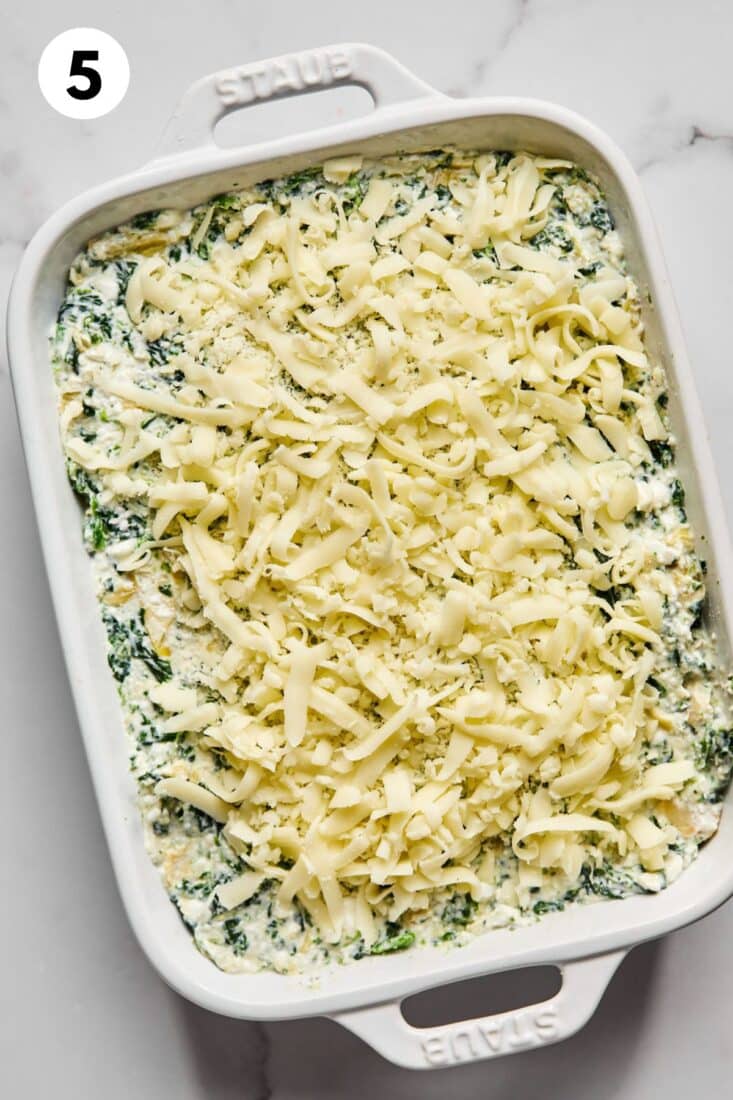 Spinach and artichoke dip in a baking dish topped with cheese.