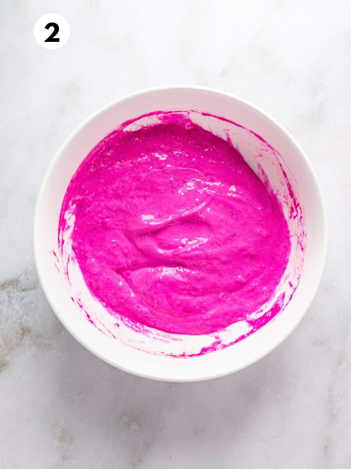 Yogurt mixture in a white mixing bowl.