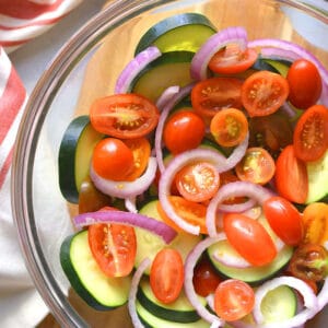 Healthy Tomato Cucumber Salad is a low calorie salad with Italian dressing. Simply toss together, chill and serve! Great as a side salad, snack or appetizer. Low Calorie + Low Carb + Gluten Free + Paleo + Vegan