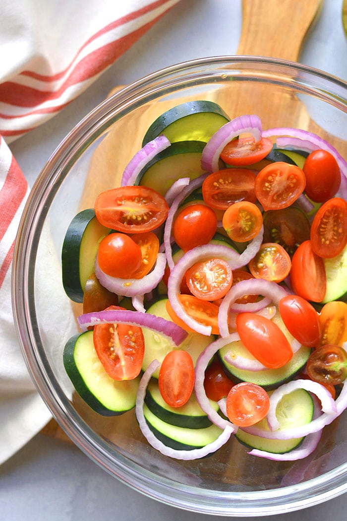 Healthy Tomato Cucumber Salad is a low calorie salad with Italian dressing. Simply toss together, chill and serve! Great as a side salad, snack or appetizer. Low Calorie + Low Carb + Gluten Free + Paleo + Vegan