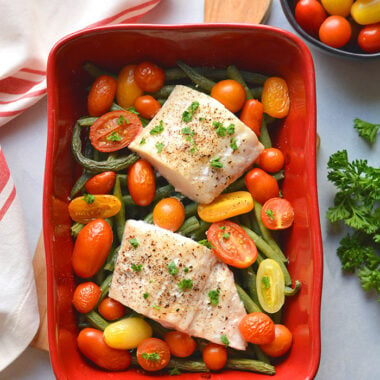 Healthy Baked Halibut with Italian flavor, lemon, tomatoes and green beans. A simple fish dinner that's tasty and effortless to make! Low Calorie + Low Carb + Gluten Free + Paleo