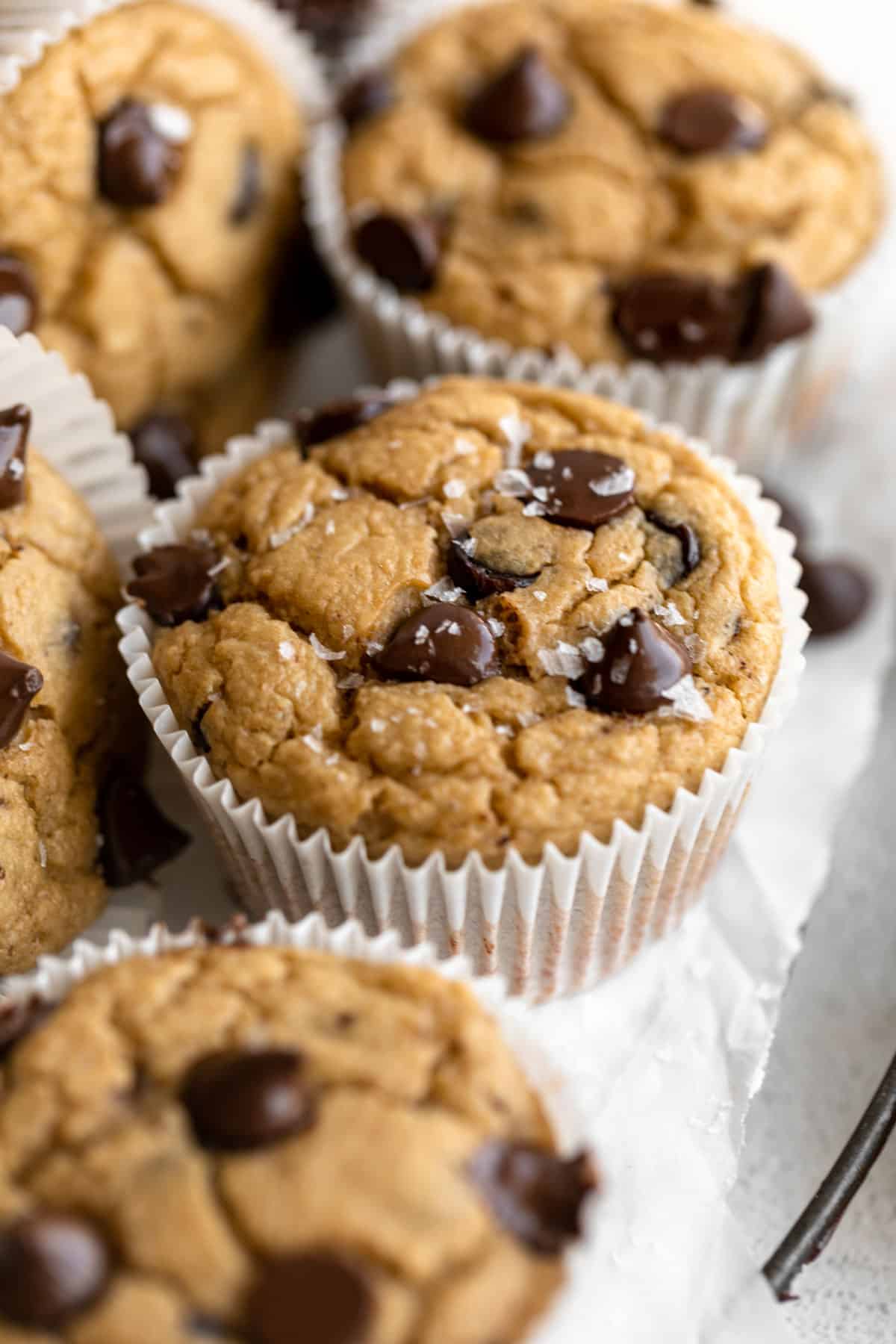 Healthy banana oat muffins stacked up on a platter with some turned on the side.