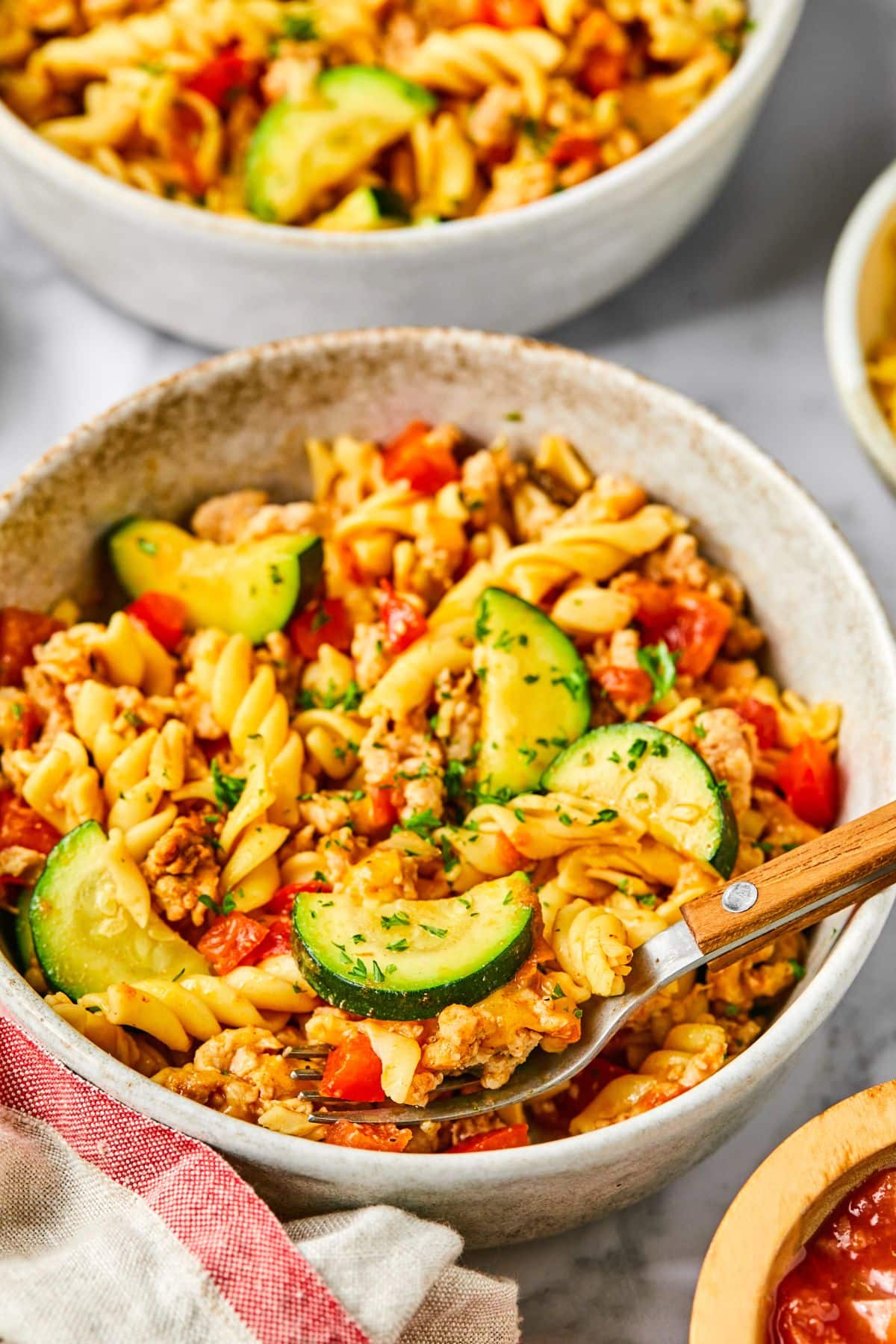 Taco pasta served up in a bowl with a fork resting to the side.
