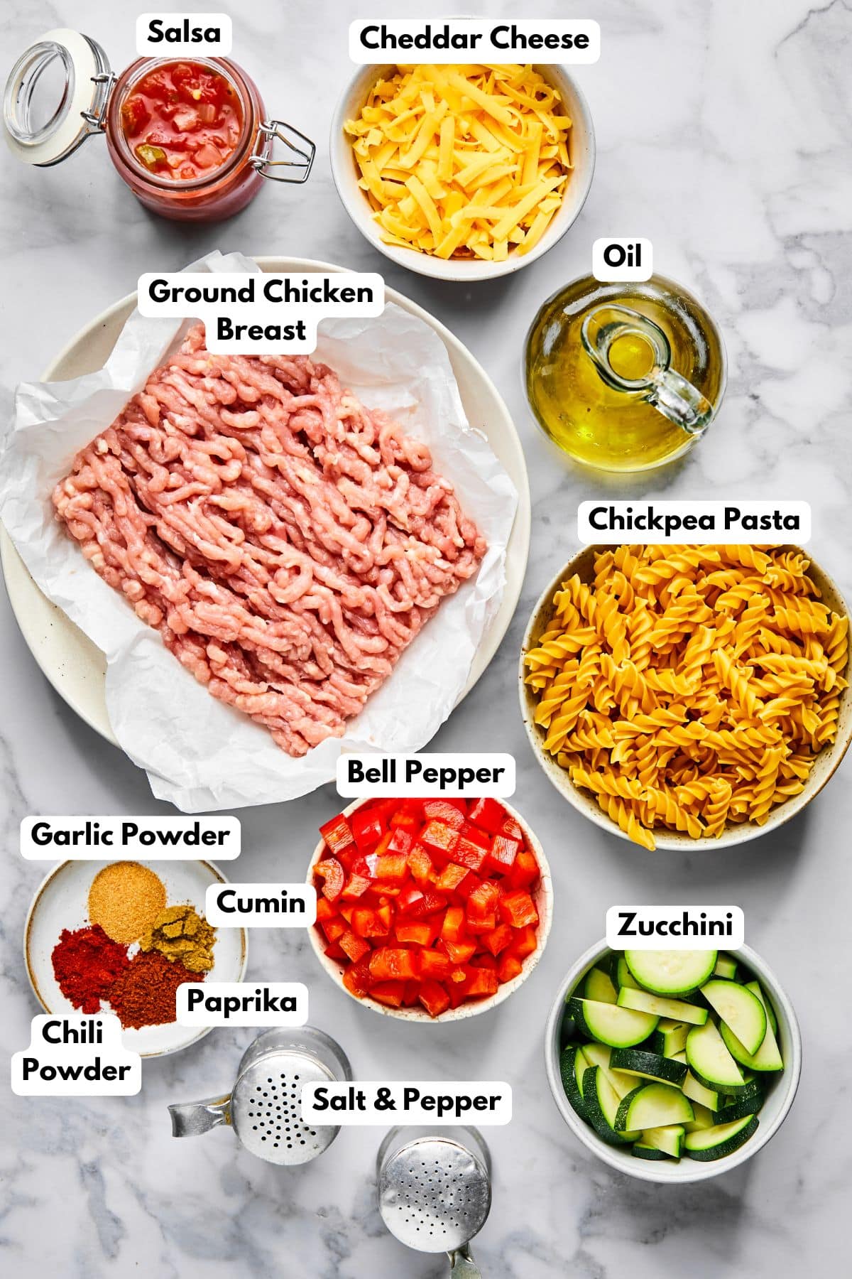 Ingredients to make taco pasta on a table in bowls.