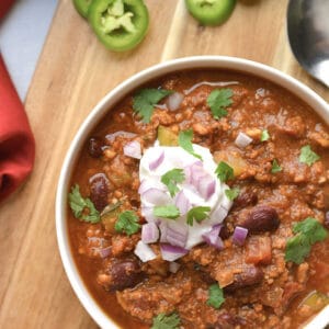 turkey chili with greek yogurt in white bowl