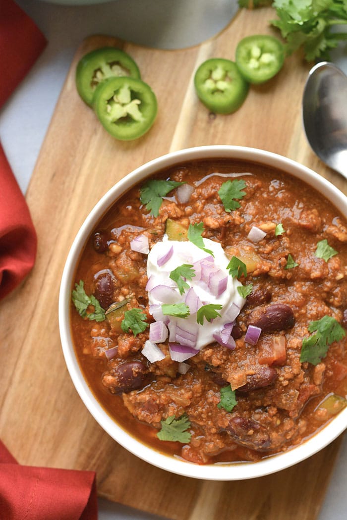 turkey chili with greek yogurt in white bowl