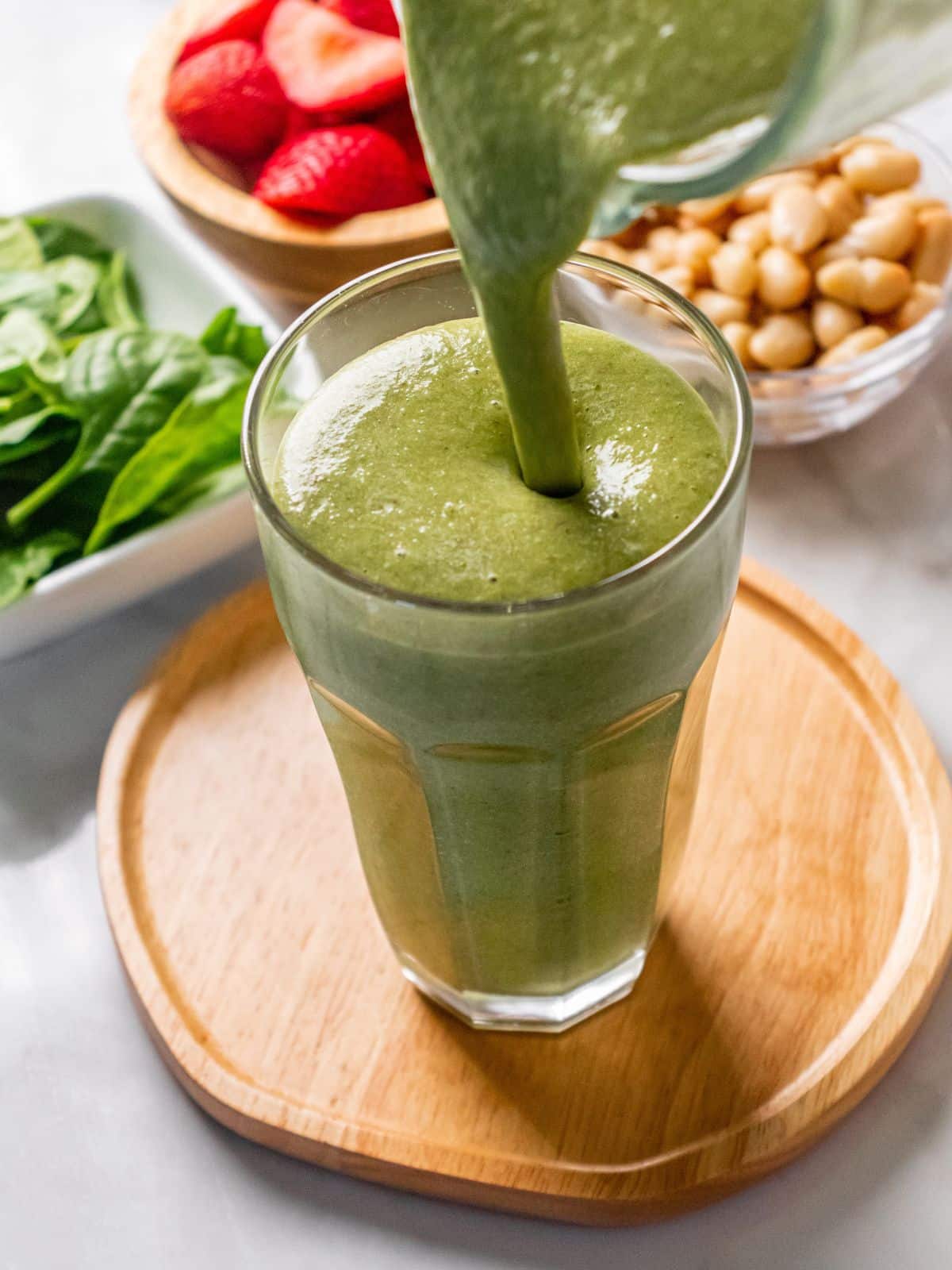 Pouring a high fiber smoothie into a glass.