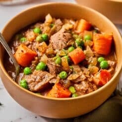 A bowl of healthy beef stew crockpot on the table.