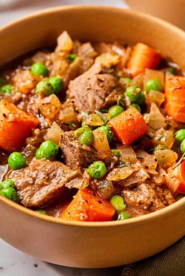 A bowl of healthy beef stew crockpot on the table.