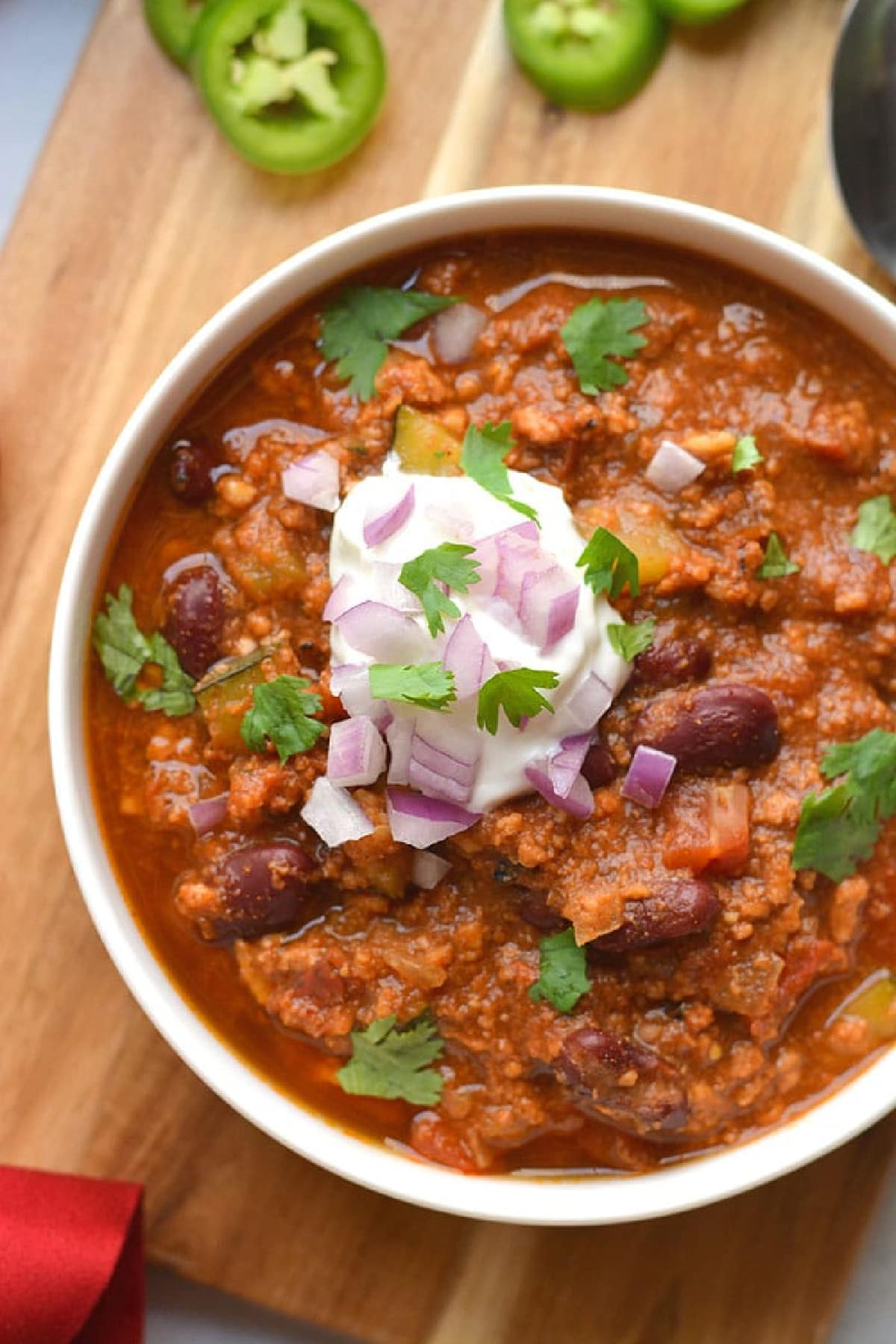 ground turkey chili and beans in a white bowl.