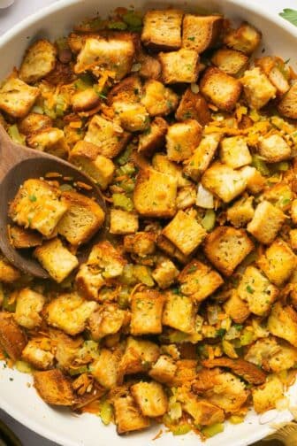 Healthy stuffing in a skillet with a wooden spoon.