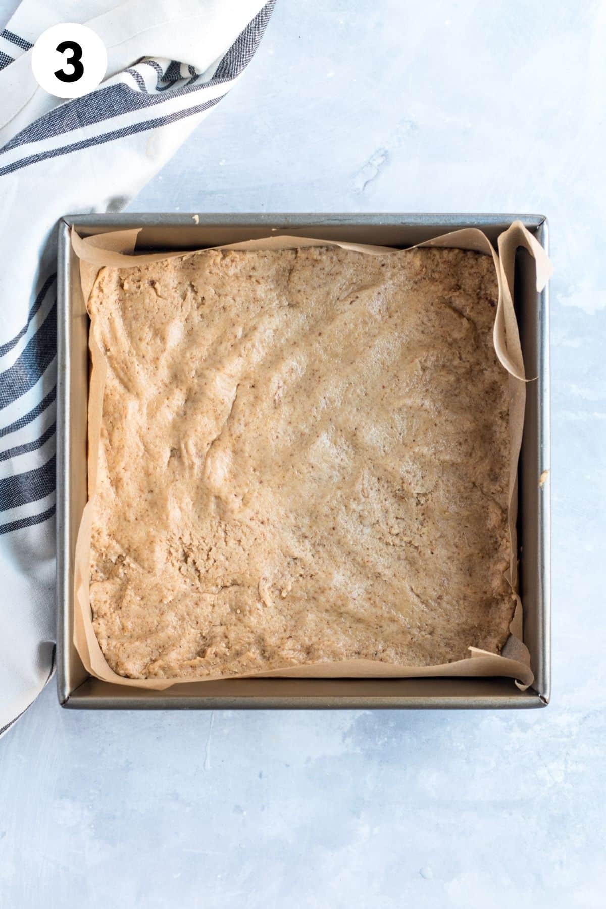 The eggnog bar mixture added to a baking pan.