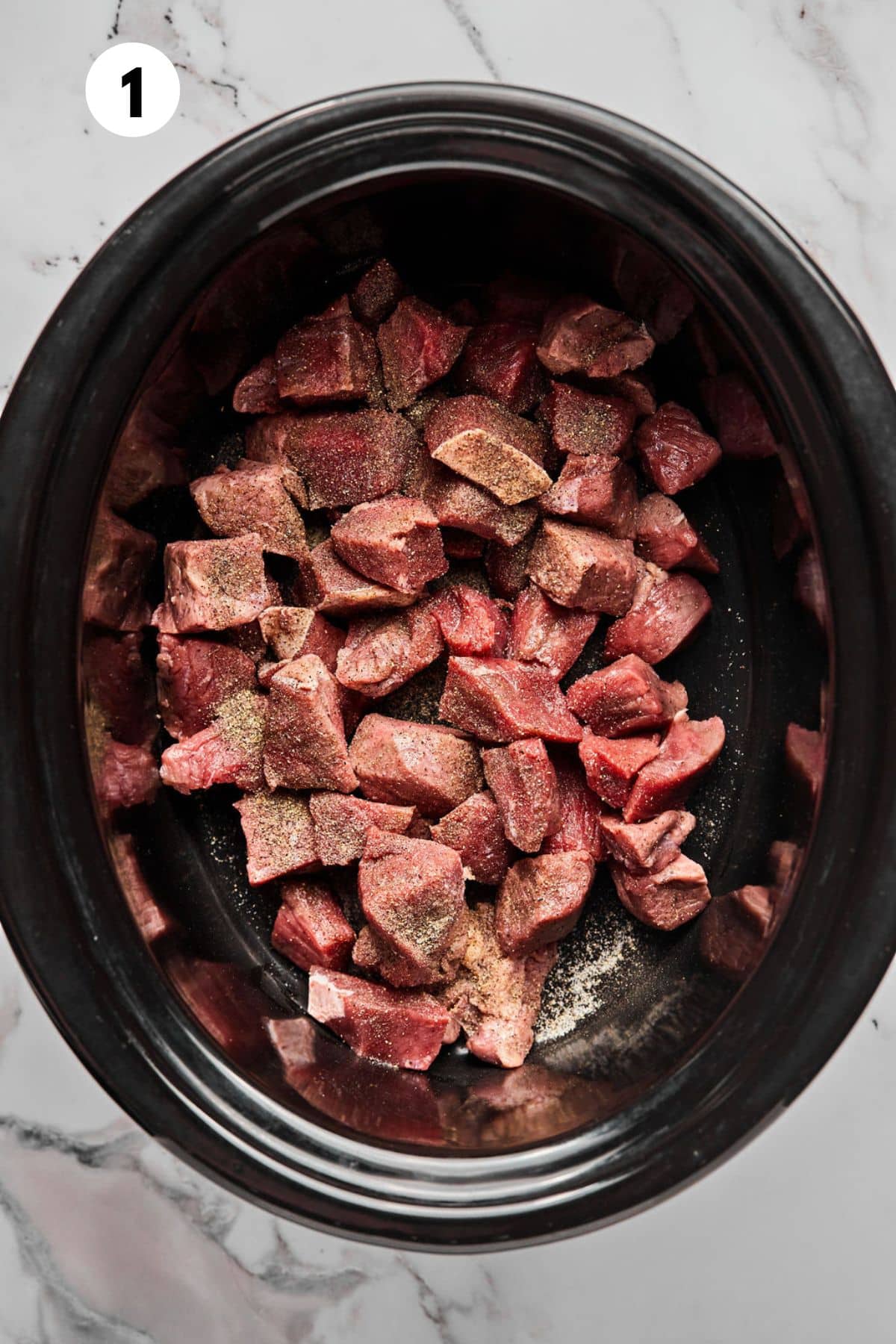 Beef stew meat in the slow cooker.