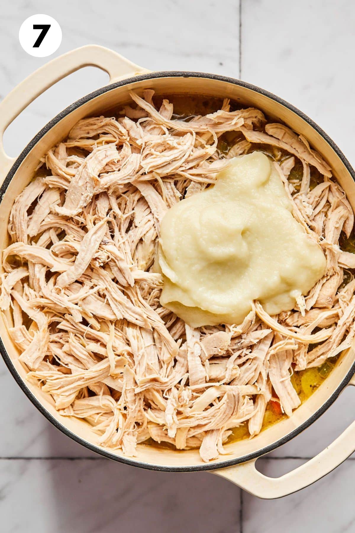 Blended cauliflower added to the pot of chicken pot pie soup.