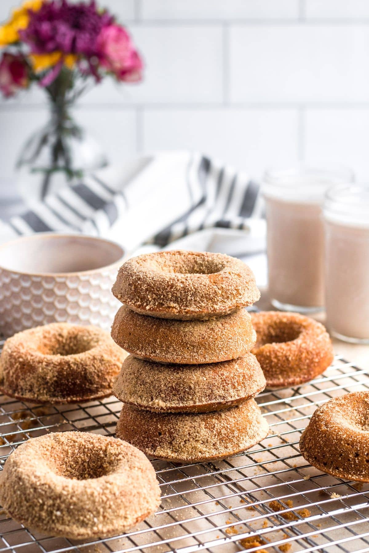 A stack of gingerbread donuts on a cooling rack.