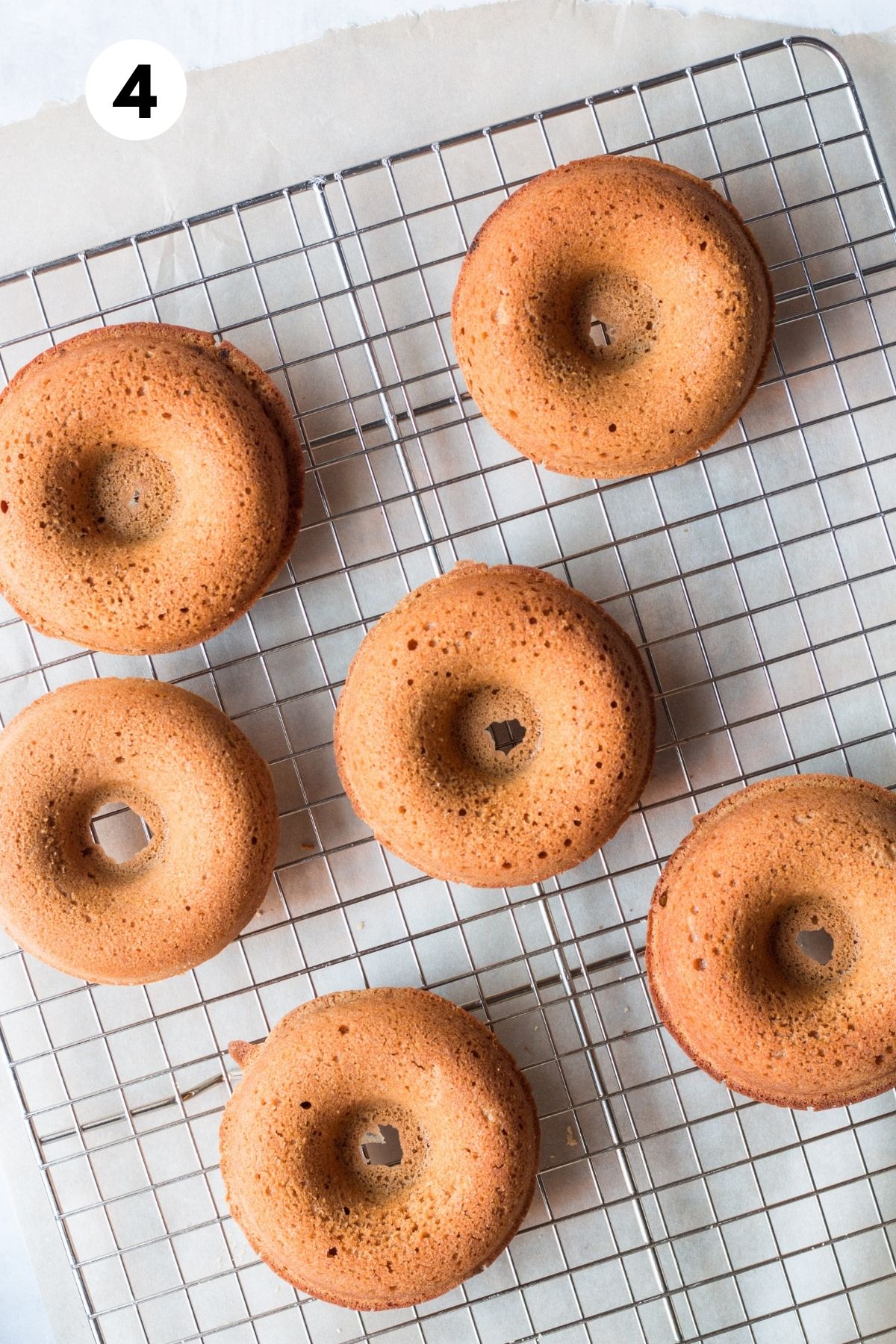 Baked donuts on a cooling rack.