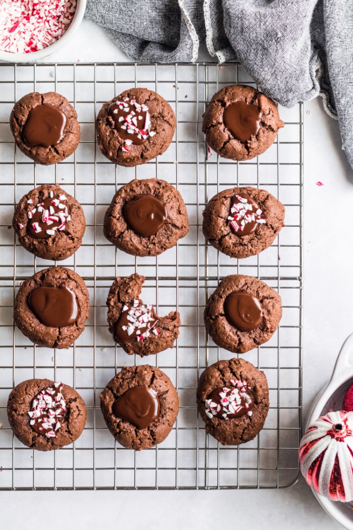 Healthy Chocolate Thumbprint Cookies made low calorie and gluten free are a delicious holiday cookie recipe with peppermint sprinkles on top! Gluten Free + Low Calorie