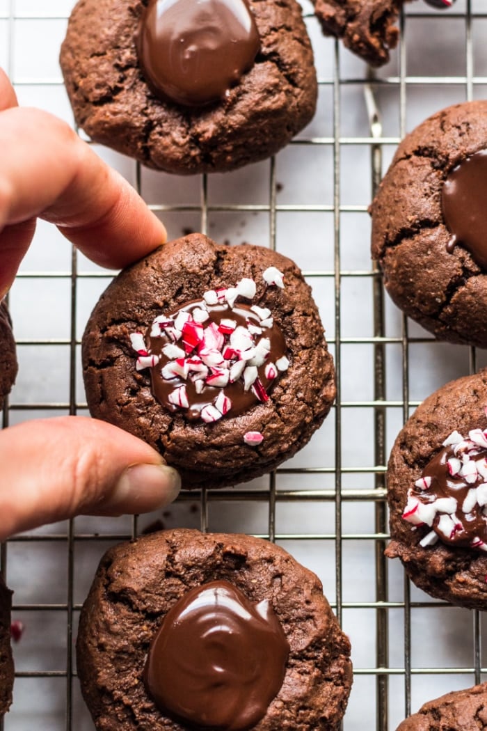 Healthy Chocolate Thumbprint Cookies made low calorie and gluten free are a delicious holiday cookie recipe with peppermint sprinkles on top! Gluten Free + Low Calorie