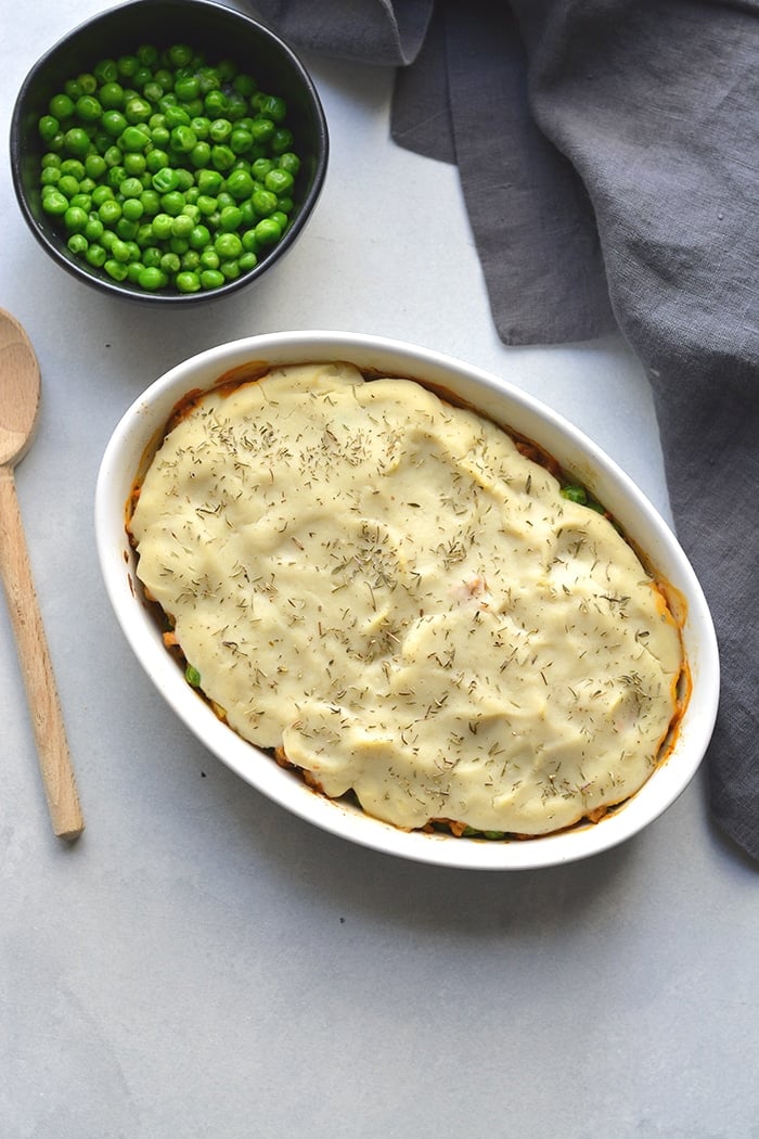 Healthy Shepherd's Pie is a low calorie recipe that's lower in carbs, high in protein and fiber. Made with a delicious roasted garlic cauliflower top and a lighter filling a for a filling and comforting winter meal. Low Calorie + Gluten Free