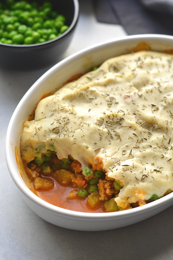 Healthy Shepherd's Pie is a low calorie recipe that's lower in carbs, high in protein and fiber. Made with a delicious roasted garlic cauliflower top and a lighter filling a for a filling and comforting winter meal. Low Calorie + Gluten Free + Paleo