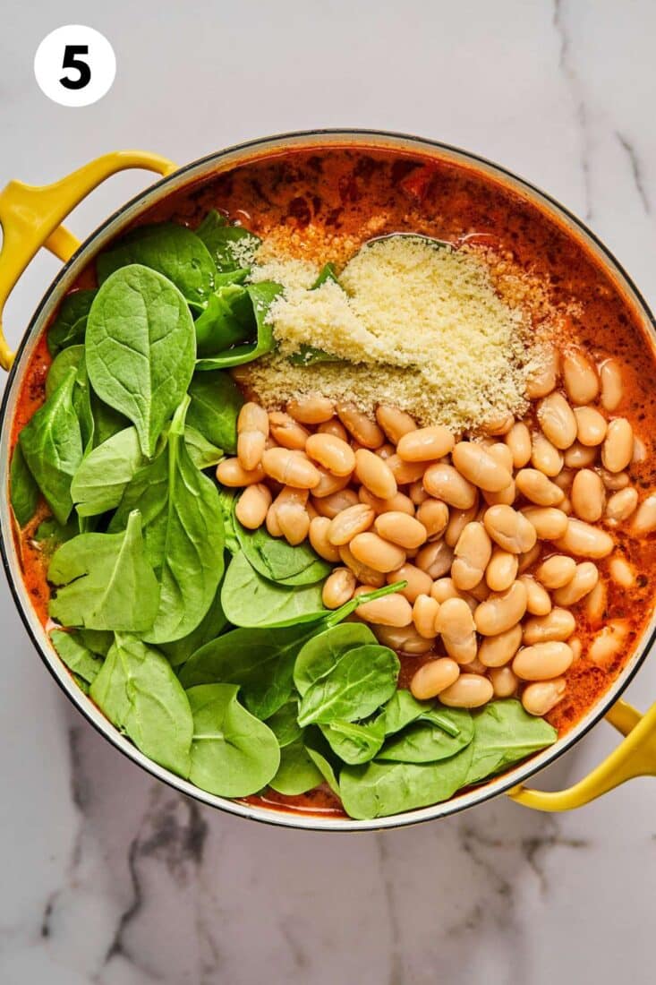 Beans, spinach, and cheese are added to the pot.