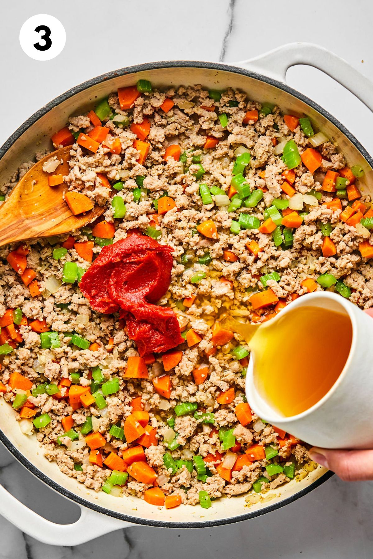 Tomato paste and broth added to the skillet.