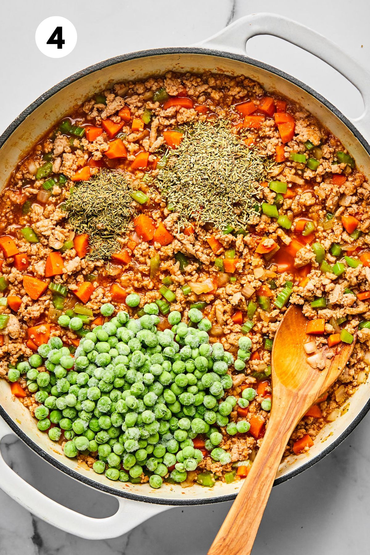 Peas and herbs added to the skillet.