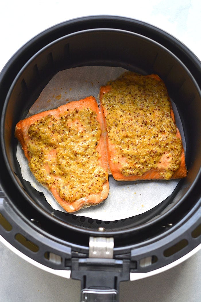 Healthy Air Fryer Mustard Salmon is a delicious mustard-glazed salmon recipe. Pair with a vegetable and another side for a simple nutrient dense meal. A naturally low calorie, gluten free meal made in 10 minutes.