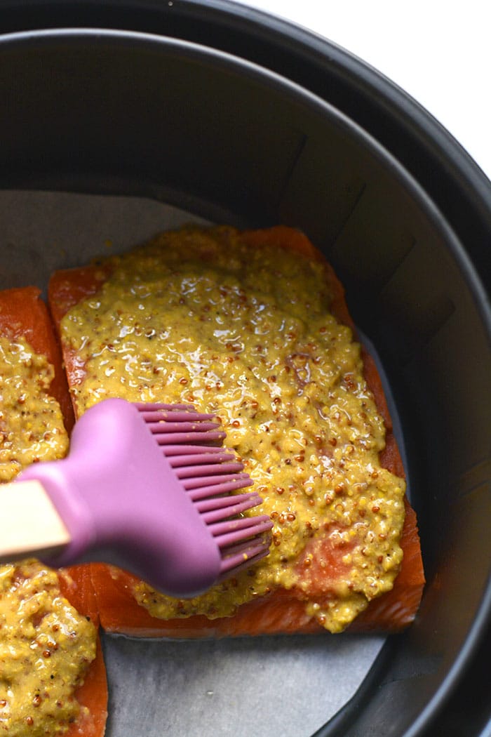 Healthy Air Fryer Mustard Salmon is a delicious mustard-glazed salmon recipe. Pair with a vegetable and another side for a simple nutrient dense meal. A naturally low calorie, gluten free meal made in 10 minutes.