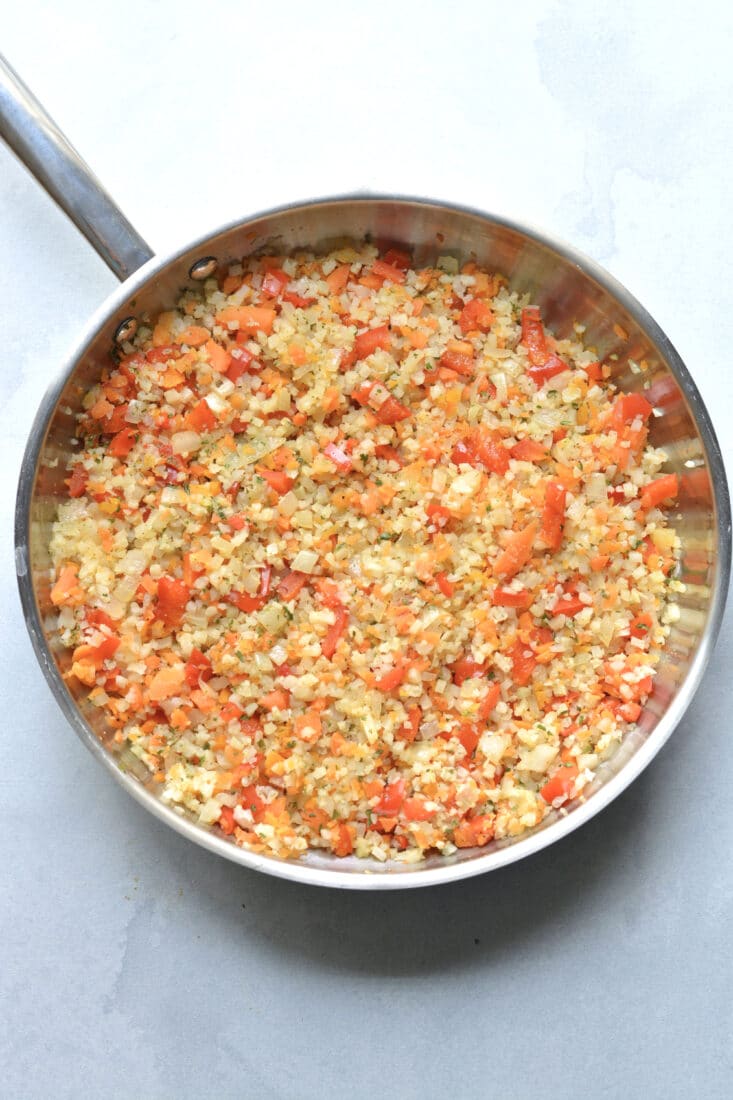 carrots onions cauliflower rice in a skillet