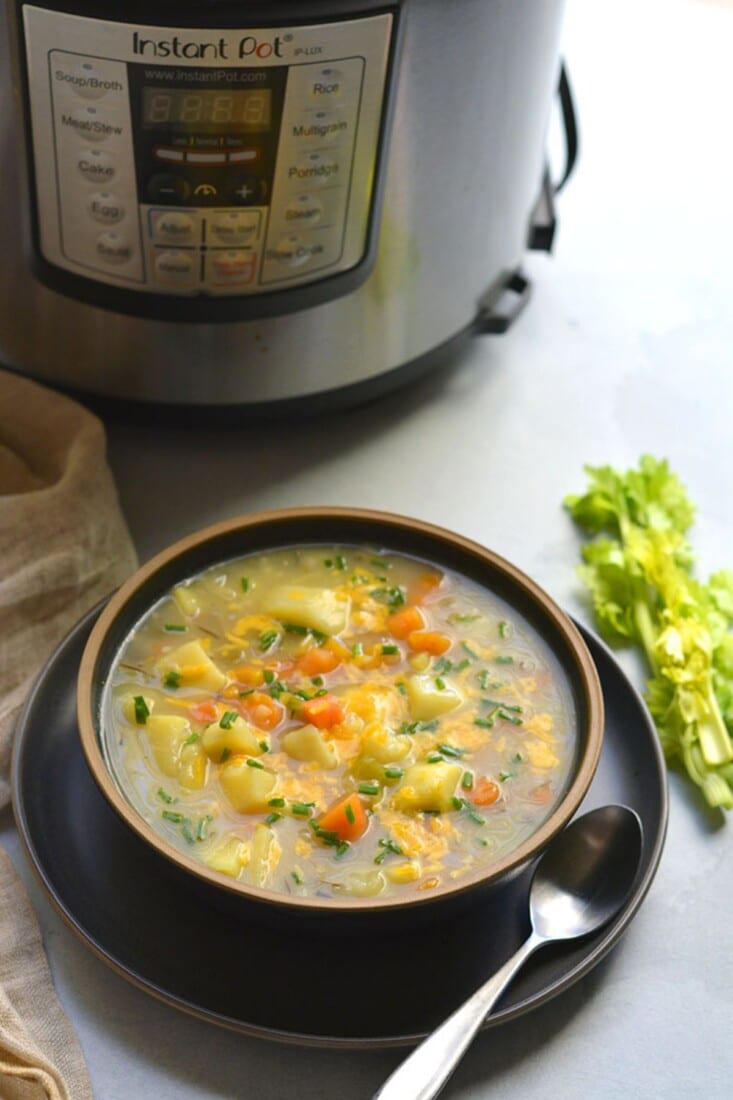 A bowl of healthy potato soup in front of an Instant Pot.