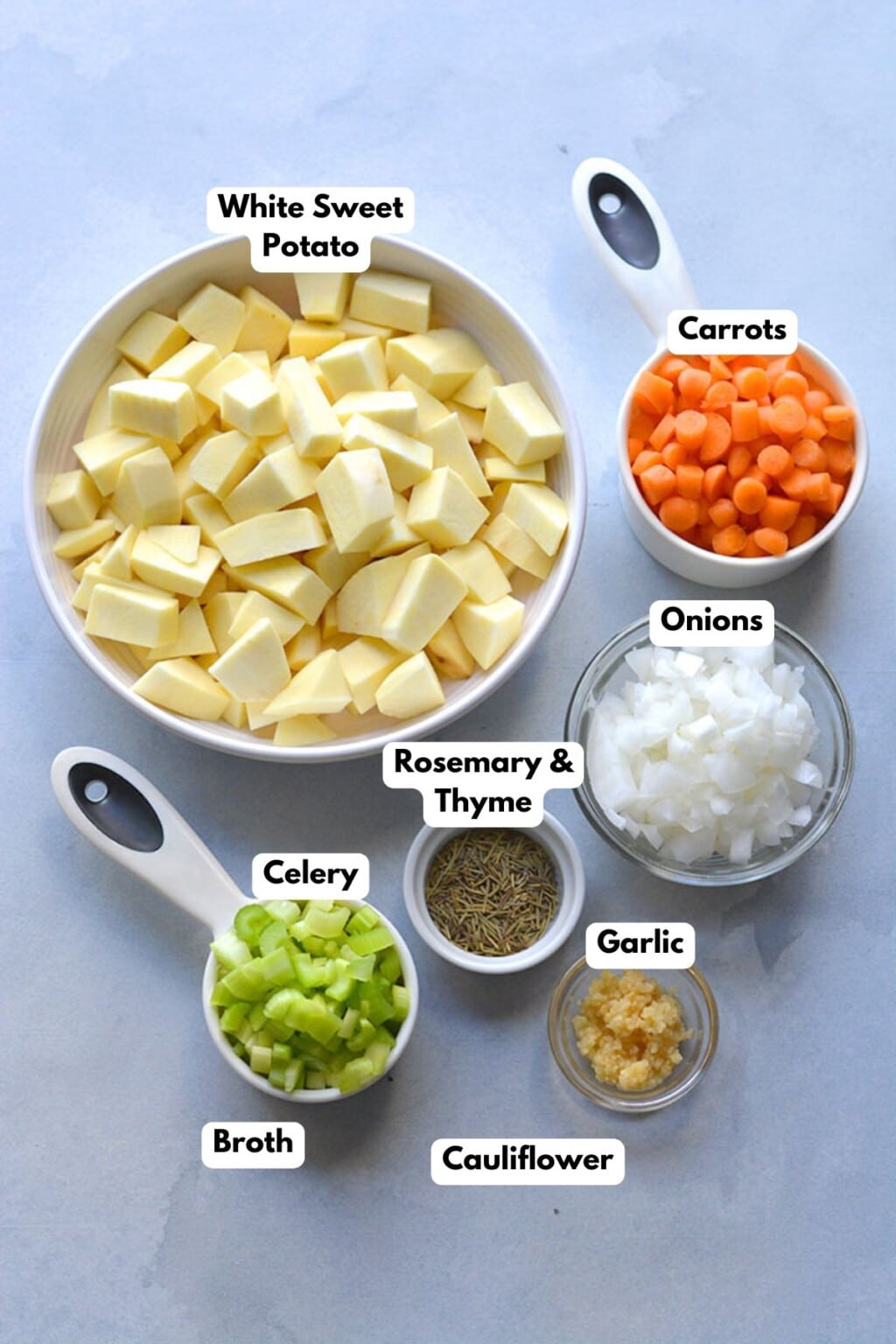 Ingredients to make a healthy potato soup on a table in bowls.