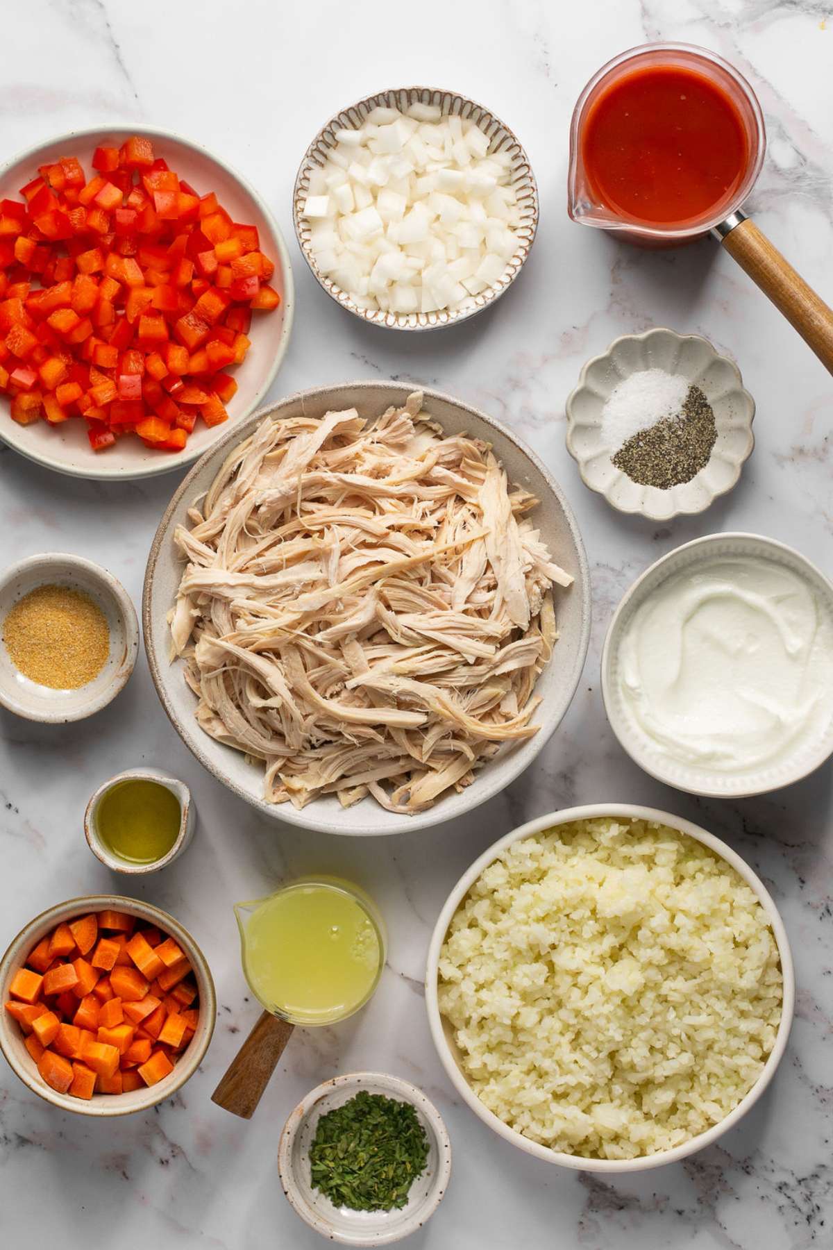 Ingredients to make buffalo chicken casserole on the table before cooking.