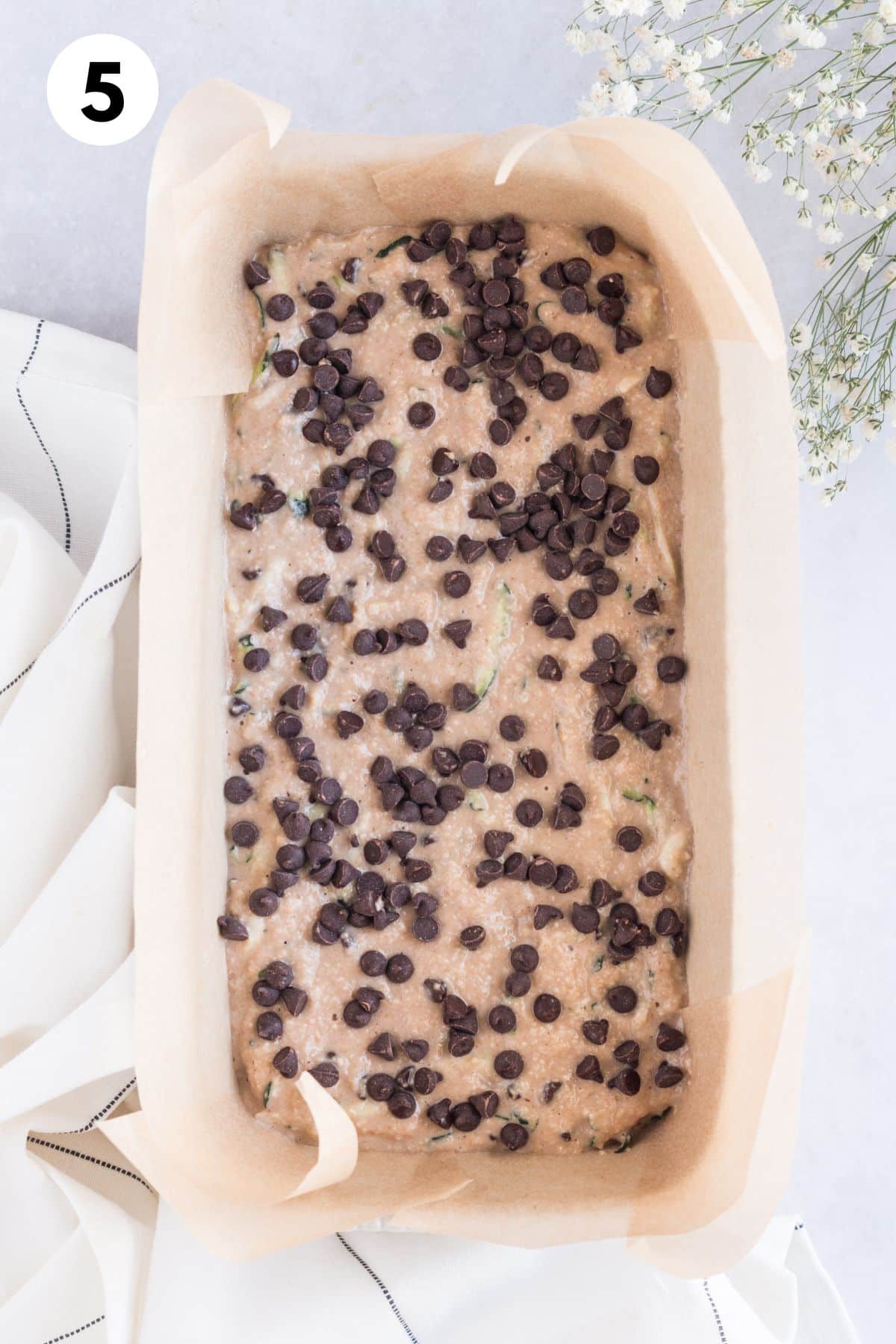 Zucchini bread batter in a loaf pan.