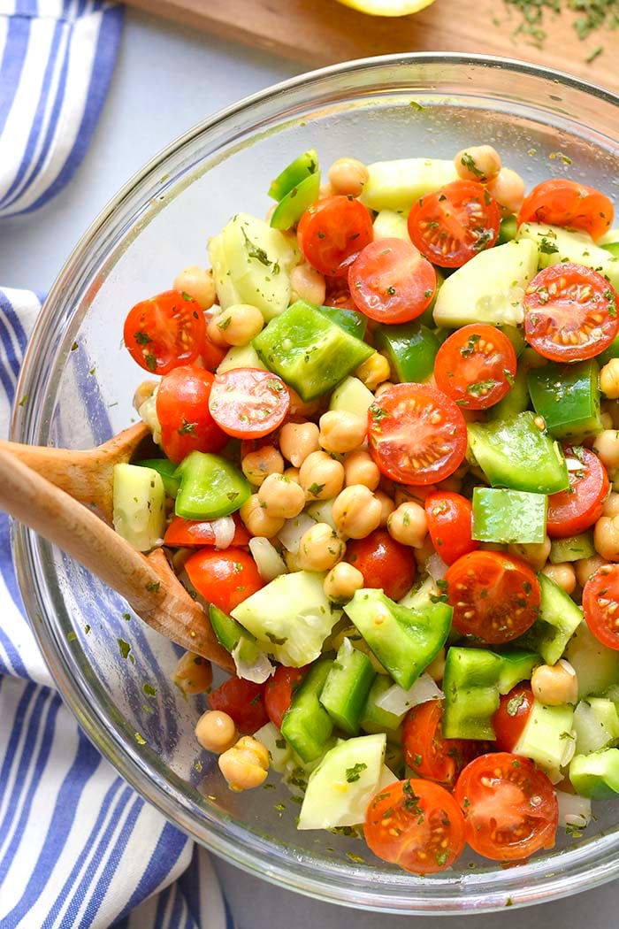 Healthy Chickpea Tomato Cucumber Salad is a low calorie side dish that's easy to make, delicious and doubles as an appetizer. A light and filling side salad that goes easily with any meal and great for warm weather eating.
