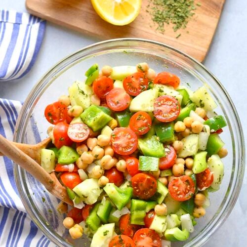 Healthy Chickpea Tomato Cucumber Salad is a low calorie side dish that's easy to make, delicious and doubles as an appetizer. A light and filling side salad that goes easily with any meal and great for warm weather eating.