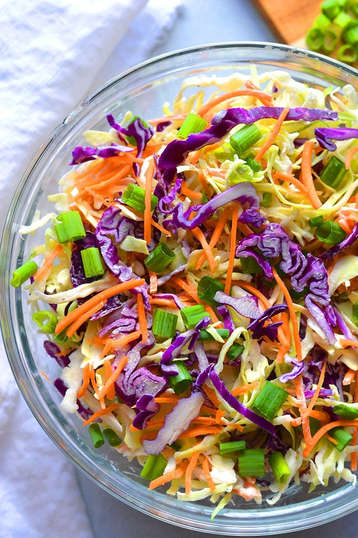 Healthy Low Calorie Coleslaw made with Greek yogurt instead of mayo and no added sugar. This simple, healthy coleslaw recipe is bursting with vegetables and nutrients while being lower in calories and fat.