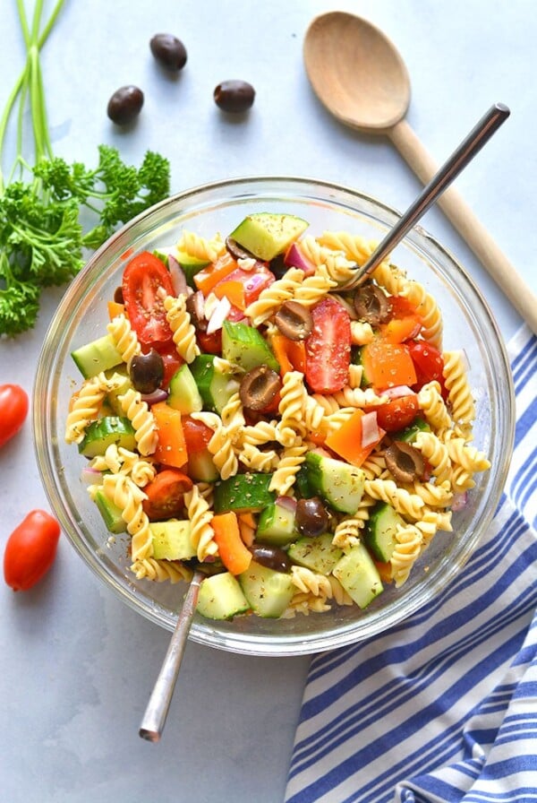 This Low Calorie Pasta Salad is loaded with vegetables and chickpea pasta. Made light with healthy ingredients this tasty, gluten free and dairy free pasta salad recipe is one you will make time and again. Perfect for summer eating as a side dish or appetizer!