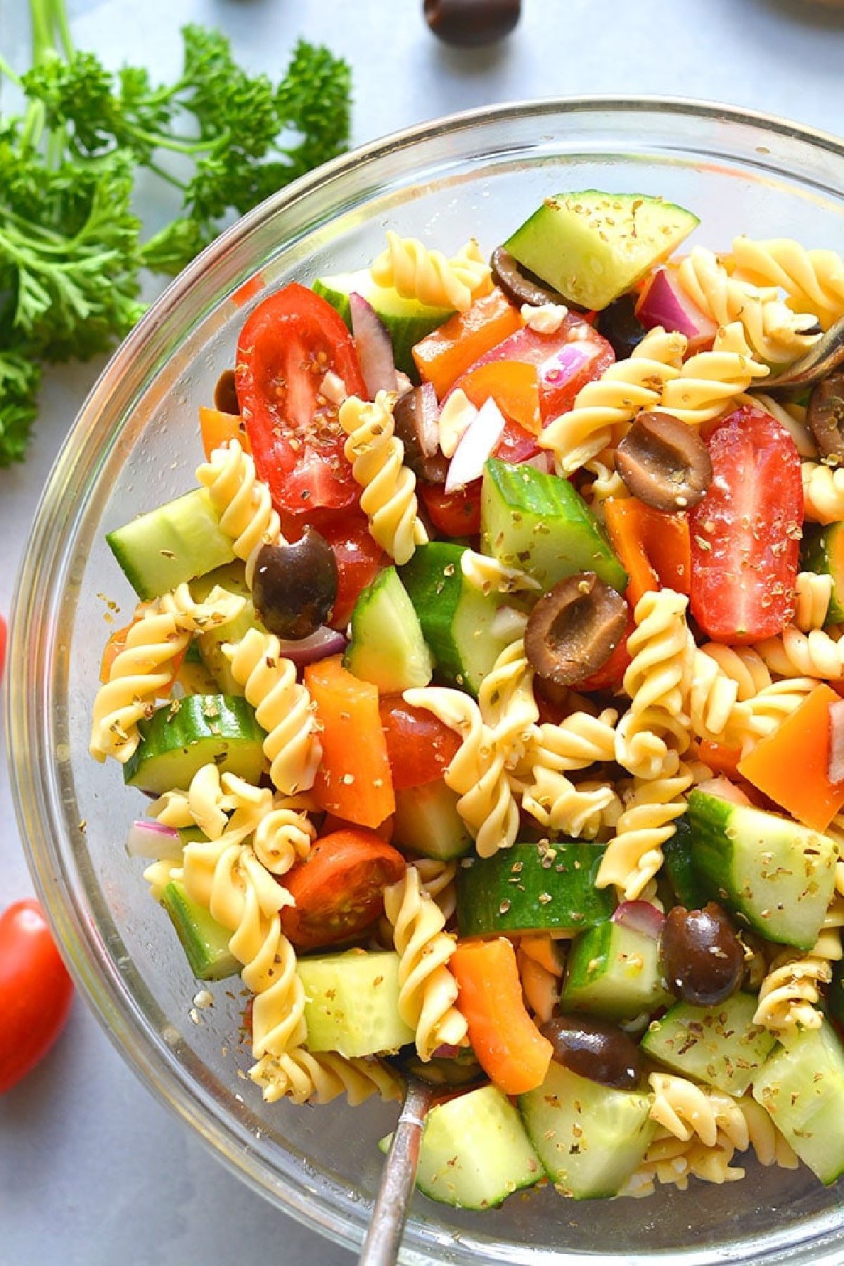 pasta salad in a clear bowl.